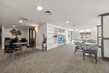 A living room with a couch and chairs and a table